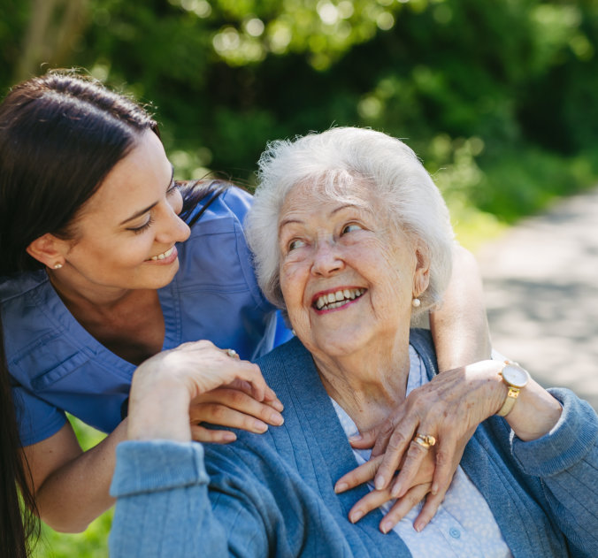 elderly and caregiver smiling