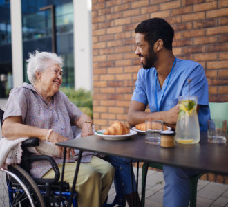 nurse and senior eating together