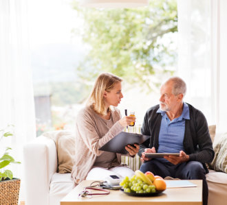 nurse and elder man talking